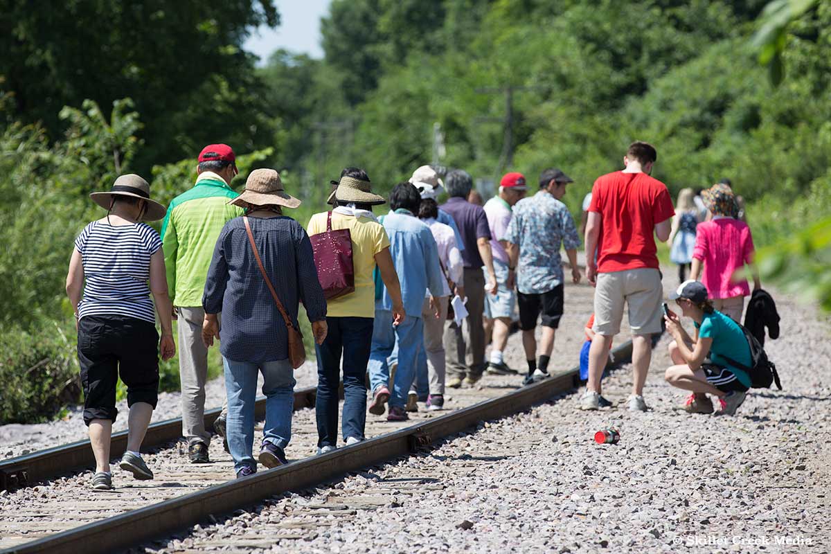 Park visitors walking the train tracks