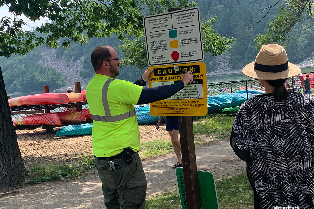 Ranger posting E.Coli Notice At Devil's Lake