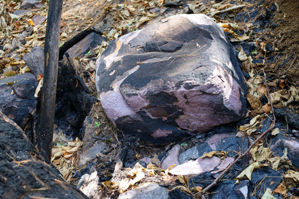 Quartzite boulder flaked off due to heat.